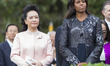First Lady Michelle Obama and Madame Peng Liyuan of China listen during an official State...