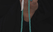 A Shi'ite Muslim woman holds a worry-beads as she prays at Jamkaran holy mosque after the...