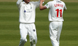  Kiran Carlson of Glamorgan celebrates with Andy Gorvin of Glamorgan after taking a wicket...