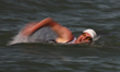 A participant competes during the swim leg of a local triathlon competition at East Coast...