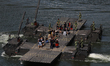 People take a ride on the M3G military raft along the waters of Marina Bay during the Army...