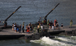 People take a ride on the M3G military raft along the waters of Marina Bay during the Army...