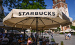Starbucks Coffee shop summer garden at the Main Square in Krakow, Poland on June 6th, 2022...