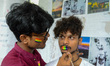 Participants are seen drawing rainbow colors on each others face during a pride rally in K...