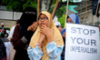 Malaysian Muslim women holds up "Stop your imperialism" banner during a protest against th...