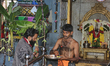 Tamil Hindu priest performs prayers at a small roadside temple in Chennai, Tamil Nadu, Ind...