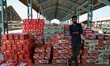 Fruit Traders stand near the fresh packed Apple boxes at Mustafa Memorial Fruit Mandi in S...