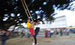 Local girls playing swing during the festival of Dasain in Bungamati, Lalitpur, Nepal, on...