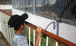 A Palestinian child looks at lions sitting inside a cage at nama zoo in Gaza city on July...