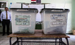 Ballot boxes for the parliamentary elections watched by a judge in a poll station of 6th o...