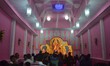 Indian Hindu devotees gather to offer prayers in front of an idol of the Goddess Durga in...