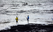 People enjoying the high waves at Arabian Sea in Mumbai on 05 August, 2022. 