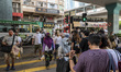 People wearing face mask crossing a street on August 7, 2022 in Hong Kong, China. Hong Kon...