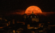 A sturgeon Super Moon rising behind San Bernardino church dome in L'Aquila (Abruzzo, Italy...