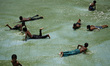 Children are enjoying the Hatirjheel Lake during the hot summer weather in Dhaka as hot an...