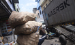 A man carries essential goods near Colombo, Sri Lanka. August 25, 2022The import of over 3...