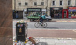 Wasteworx recycling truck as seen near bins full of trash. Mounting piles of waste in the...