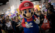 Mario is followed by dozens of young fans during the XXI Edition of  Manga Fair (Salo del...