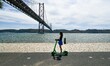 People are seen performing outdoor activities in the vicinity of the Tejo river boulevard,...