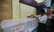   A teacher casts her vote during an advance voting at a township administration office in...