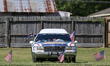 A car proudly displays a number of right-wing symbols and slogans.  