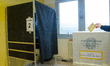 A voter casts his ballot during general elections in a polling station in L’Aquila, Italy,...