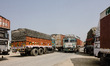 Trucks are lining up on the road that leads to the closed border crossing between Sunauli...