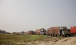 Trucks are lining up on the road that leads to the closed border crossing between Sunauli...