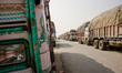 Trucks are lining up on the road that leads to the closed border crossing between Sunauli...