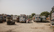 A group of truck drivers waits at the roadside near to the closed border crossing between...