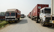 Trucks are lining up on the road that leads to the closed border crossing between Sunauli...