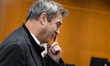 Prime Minister of Bavaria Markus Soeder touches his nose before consultations between Fede...