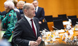 German Chancellor Olaf Scholz (C) arrives to consultations between Federal Government and...
