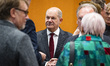 German Chancellor Olaf Scholz (C) talks with other attendants before consultations between...