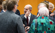 German Chancellor Olaf Scholz (C) talks with other attendants before consultations between...
