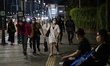 People walk on pedestrian in Jakarta on 13 November 2022. Indonesia's economy expanded at...