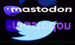 Twitter logo displayed on a phone screen and Mastodon logo displayed on a laptop screen ar...