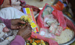 Nepalese Hindu woman, who is on fasting, awaits to offers holy flower to devotees on the l...