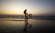 A Palestinian boy on his bike in front of Gaza beach during sunset, on February 10, 2023. 