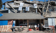 Clean up crews with heavy machinery and excavators worked to remove rubble and collapsed b...