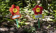 Two fake flowers reading 'Talke caof nature and of yourself' and 'Happiness is here' are s...