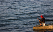 A Palestinian man fish with rods along the beach in Gaza City, on March 1, 2023.  