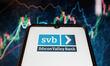 In this photo illustration the Silicon Valley Bank logo seen displayed on a smartphone scr...