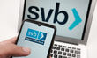 In this photo illustration the Silicon Valley Bank logo seen displayed on a smartphone scr...