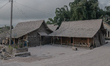 Houses covered by ash after Mount Merapi, Indonesia's most active volcano spews hot clouds...