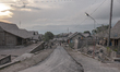 Houses covered by ash after Mount Merapi, Indonesia's most active volcano spews hot clouds...