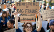 A student reacts with a placard reading 'Minister : big scam'. France's labour unions and...