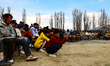 
Kashmiri youth are watching a performance by artists during a musical program organized...