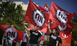 Protestors wave red and white flags from the far-right political party "Alianza Nacional"...