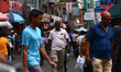 People walk past shops at Pettah Market in Colombo On March 24, 2023. 